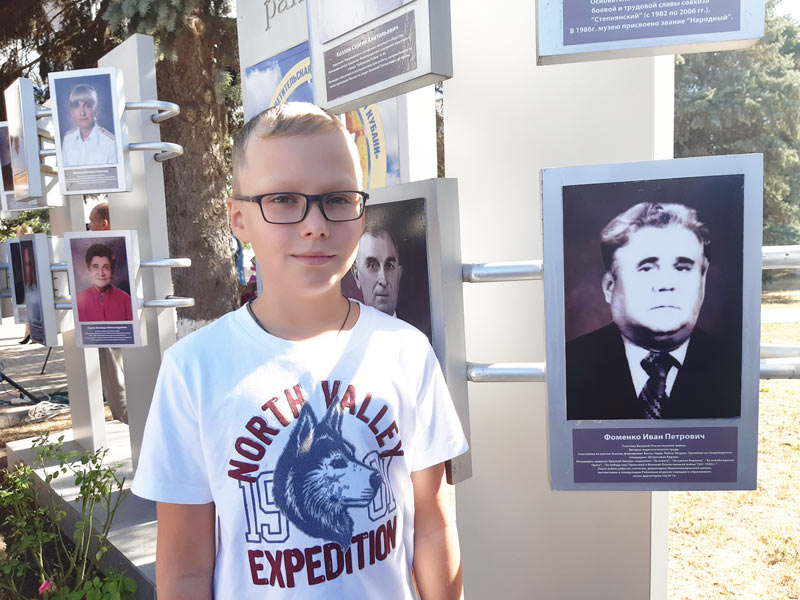 Иван Фоменко-младший у Доски почёта с портретом прадеда танкиста, педагога Ивана Фоменко.